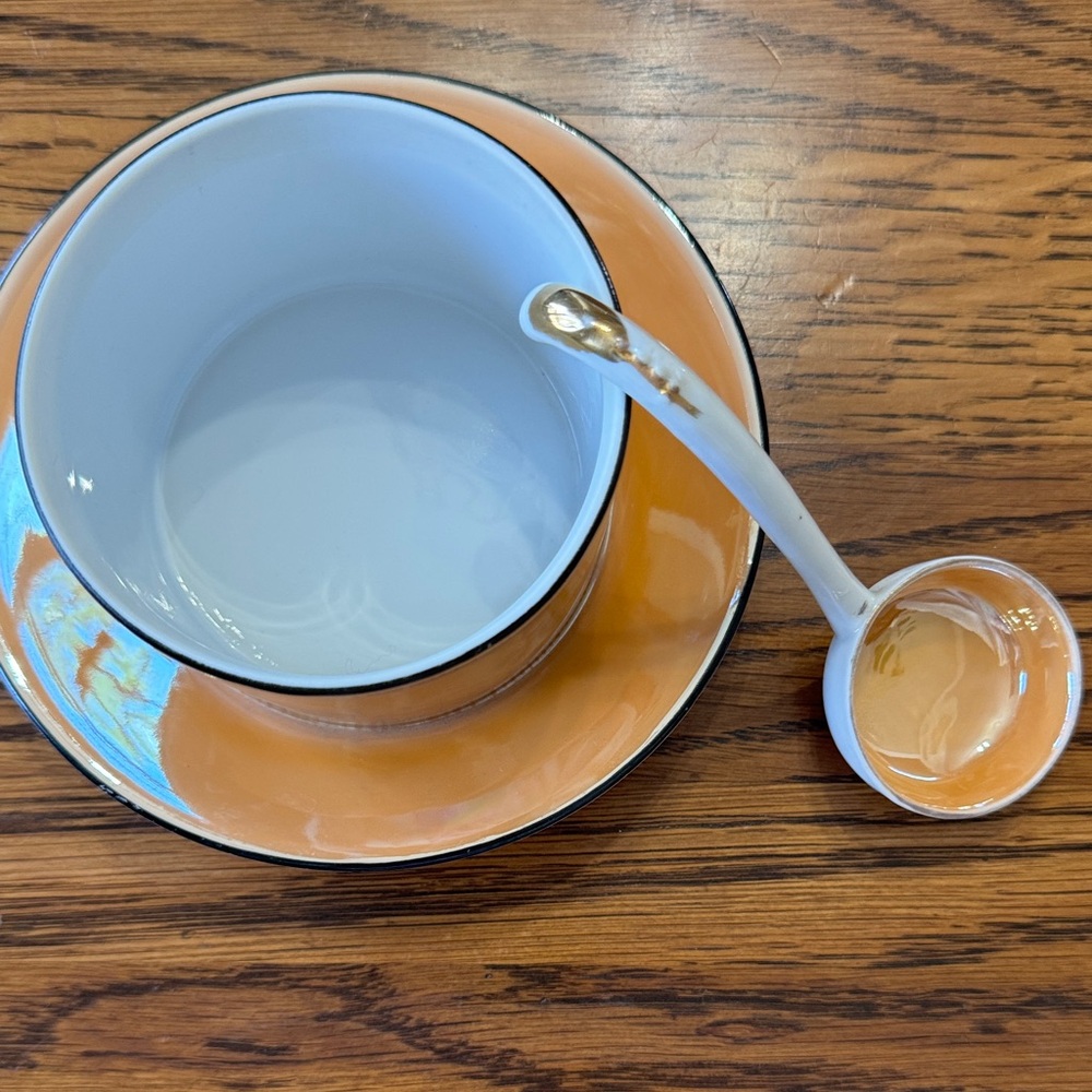 Orange lusterware cup, saucer and spoon
